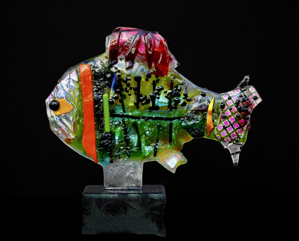 Kiln formed glass mounted on a wood base. 10 inch high by 11 inch wide by 4 inches.